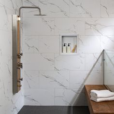 a bathroom with white marble walls and floor