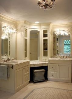 a large bathroom with double sinks and two mirrors