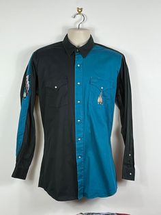 An awesome vintage cowboy shirt, made in Canada by MWG.   The condition is great for age with no damage or marks, it would look great worn at festivals or gigs and any summer beach parties too!  Perfect for a man or woman and could be worn oversized on a smaller frame  :)  It would also be easy to alter it for a smaller fit if need be (I could do this for prior to shipment). Measurements are: Chest pit to pit- 23" Sleeve shoulder to cuff- 25" Garment Length- 32" Collar- 15.75" Thanks for looking Retro Blue Tops For Rodeo, Vintage Blue Tops For Rodeo, Blue Retro Tops For Rodeo, Blue Vintage Western Style Tops, Boho Rocker, Cowboy Shirt, Summer Beach Party, Cowboys Shirt, Vintage Cowboy