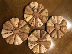 three pieces of paper that have been made into windmills on top of a wooden table