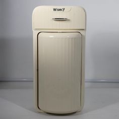 an old fashioned white refrigerator with the word wise on it