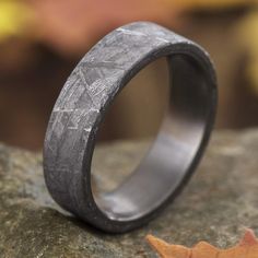 a wedding band that is made out of wood and has an etched pattern on it