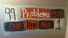 a sign that says 99 problems but our line anti 1 is painted on the wall