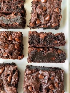 chocolate brownies are arranged on a white tray