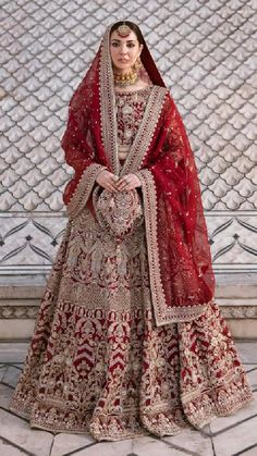 a woman in a red and gold bridal gown