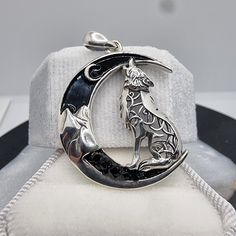 This 925 Sterling Silver Celtic Wolf Crescent Moon Pendant is a mystic emblem of intuition and transformation, crafted with a soulful Celtic twist. The pendant displays a howling wolf, intricately adorned with Celtic knotwork, poised within a sleek crescent moon embedded with black zircon stones that add a touch of nocturnal sparkle. The Celtic wolf is a symbol of guidance and guardianship, while the crescent moon represents the cycles of change and renewal. Together, they form a powerful amulet Mystical Sterling Silver Jewelry, Mystical Engraved Silver Jewelry, Mystical Sterling Silver Jewelry Stamped 925, Spiritual Moon-shaped Collectible Jewelry, Moon Phase Spiritual Jewelry, Wolf Symbolism, Celtic Wolf, Mystical Jewelry, Celtic Mythology