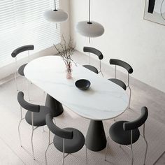 a white table with black chairs around it