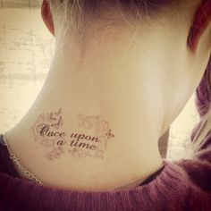 a woman with a tattoo on her neck saying once upon a time