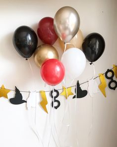 a bunch of balloons that are on a string