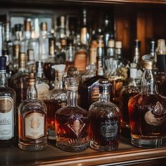 several bottles of alcohol lined up on a bar