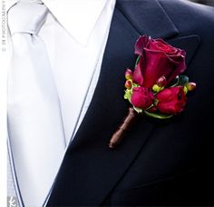 a man in a suit with a boutonniere on his lapel