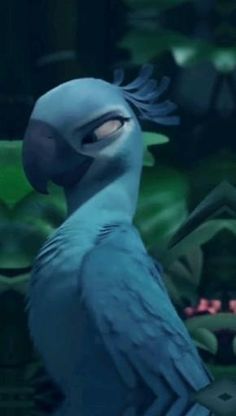 a blue bird sitting on top of a tree branch in front of green leaves and plants