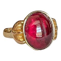 Step back to a time of refined elegance with this Victorian Garnet Signet Ring, a splendid piece that exudes the charm of the early 19th century. This impressive ring features a large cabochon garnet, measuring 14.4x11.5 mm, set in a distinctive signet style. The garnet is closed backed, emphasizing its rich, deep color and classic appeal.  Originally crafted around 1840-50, the ring has been expertly re-shanked; while the top mounting and the intricately detailed clawed feet are made of 15 karat gold, the band itself has been updated with 9 karat gold. Measuring 15.3 mm north to south and 19.3 mm across at the face, the ring sits 6 mm off the finger and narrows to 2.5 mm at the back. Weighing 4.8 grams and sized at 10, this well-loved ring showcases both historical craftsmanship and a tim Luxury Red Cabochon Ruby Ring, Luxury Ruby Ring With Oval Cabochon, Classic Domed Cabochons With Polished Finish, Elegant Formal Cabochon Ring, Luxury Ruby Ring With Cabochon Cut, Vintage Garnet Jewelry, Elegant Red Intaglio Signet Ring, Luxury Cabochon Signet Ring For Formal Occasions, Luxury Ruby Ring Oval Cabochon Polished Finish