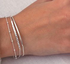 Simple and beautiful, this sterling silver bar bracelet is the perfect minimalist piece. It features a round curved bar attached to a fine chain. Wear it on its own or layer with other pieces from our collection and it's adjustable! 💖 Details 925 Sterling Silver Length 2 sizes:  Small/Medium: 16.5 - 19 cm including 2.5 cm extension Medium/Large: 18 - 20.5 cm including 2.5 cm extension The other bracelets pictured are not included but are available on Etsy or my online store 💕 Online store: www.thejewellerytree.net 💕 Stay up-to-date with new designs & special offers  - FOLLOW ME   Socials: @myjewellerytree OR  https://www.facebook.com/thejewellerytree1/  💕 Need more info, feel free to email - I'd love to help 💕And please visit my store https://www.etsy.com/au/shop/TheJewelleryTreeCo to Silver Bar Bracelet, Chain Bracelet Silver, Silver Bracelet For Women, Curved Bar, Silver Bracelets For Women, Bar Bracelet, Sterling Bracelets, Silver Bar, Silver Chain Bracelet