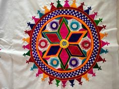 a colorful circular design on a white cloth