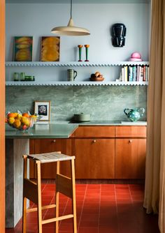 a kitchen with wooden cabinets and tiled flooring