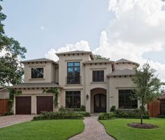 a large house with lots of windows and landscaping