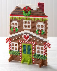 a christmas house is made out of beads