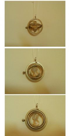 four different views of an object hanging from a string in three different frames, each with a circular design on it