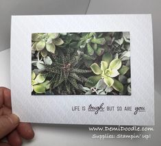 a hand holding up a card with a picture of some green plants on it and the words life is beautiful, but so are you