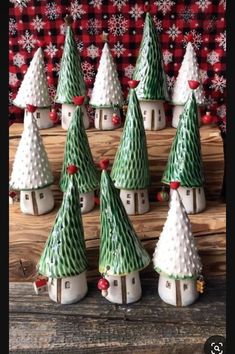 small ceramic christmas trees are sitting on a table