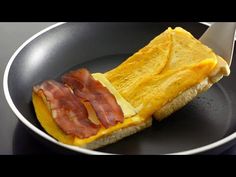 an omelet with bacon is in a frying pan