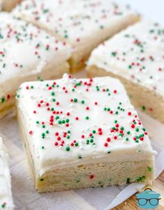 several pieces of cake with white frosting and sprinkles