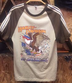 "Blackbird Vintage of Sedona, Arizona presents to you this amazing Men's Vintage Harley Davidson t-shirt, circa 1970s. This may be a 1976 Bicentennial design? This shirt is in remarkable vintage condition, considering its age. No noticeable holes or tears and the screen printed images are extremely vivid. Made in USA. Men's size M, but may fit more like a modern small. Please check measurements below. Measurements: Underarm to underarm: 16.5\" Back of Collar to hemline: 25.5\" PLEASE NOTE: This Retro Crew Neck T-shirt Made In Usa, Retro Cotton T-shirt Made In Usa, Vintage Crew Neck T-shirt Made In Usa, Retro Brown Crew Neck T-shirt, Brown Vintage T-shirt For Streetwear, Brown Vintage Tops With Graphic Print, Harley Davidson Eagle, Harley Davidson Clothing, Navy Blue Sweatshirt