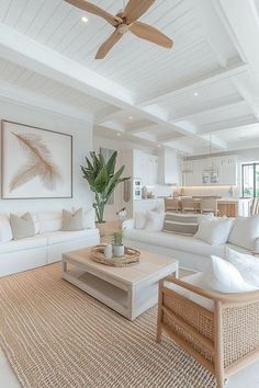 a living room filled with furniture and a ceiling fan in the middle of an open floor plan