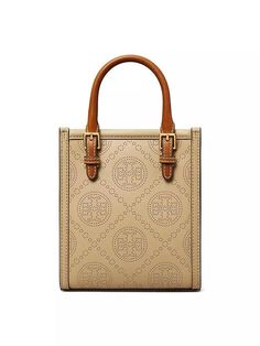 Tory Burch's leather T Monogram mini tote features a perforated pattern inspired by classic Pennsylvania Dutch quilts. This bag is completed with a soft microfiber lining, adjustable top handles, and a detachable crossbody strap..Adjustable top handles.Adjustable/detachable crossbody strap.One interior card slot.Magnetic closure.Leather.Imported.SIZE.About 6'W x 7'H x 3'D.Top handles: about 2.5' drop.Crossbody strap: about 22' drop.ABOUT THE BRAND.Since debuting her brand in 2004, New York-based designer Tory Burch has made an impact on the fashion world with her handbags and shoes, and playful-yet-polished clothing. Today, Burch remains inspired by color and travel, with her vibrant collections bursting with prints, and her instantly recognizable double-T logo drawing from Moroccan archit Designer Leather Bags With Perforations, Elegant Leather Shoulder Bag With Perforations, Luxury Perforated Shoulder Bag, Chic Leather Shoulder Bag With Perforations, Leather Shoulder Bag With Perforations, Leather Bag With Perforations For Daily Use, Everyday Perforated Tote Shoulder Bag, Everyday Use Tote Shoulder Bag With Perforations, Perforated Tote Shoulder Bag For Everyday Use