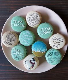 a white plate topped with cookies covered in frosting and decorated with different types of words