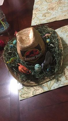 a straw hat sitting on top of a table covered in fake eggs and other toys