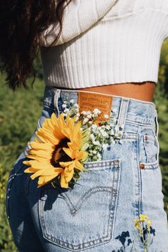 a woman with a sunflower in her pocket