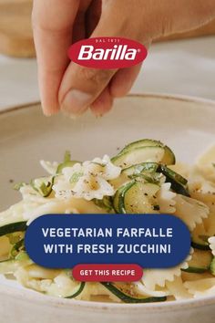 a bowl filled with pasta and vegetables on top of a table