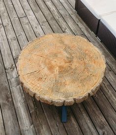 a tree stump sitting on top of a wooden deck