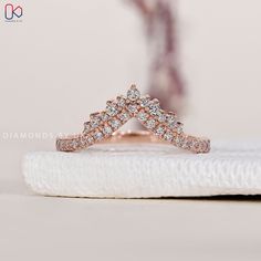 a diamond ring sitting on top of a white napkin