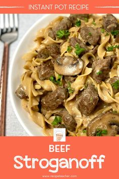 beef stroganoni with mushrooms and parsley in a white bowl next to a fork