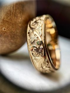 two gold wedding bands sitting on top of each other