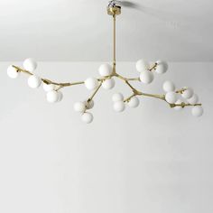 a chandelier with white balls hanging from the ceiling