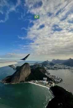 an airplane flying over the ocean and land