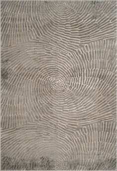 an area rug with wavy lines on the ground in grey and beige colors, as well as a circular design