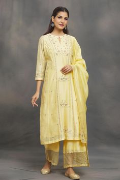 Pastel yellow kurta with aari, zardozi, sequin emboidery in floral pattern. Paired with flared pant and border embroidered dupatta. 
Components: 3
Pattern: Embroidery
Type Of Work: Aari, zardozi, sequin, thread
Neckline: Keyhole
Sleeve Type: Long sleeves
Fabric: Kurta and Dupatta: Chanderi, Pant: Chanderi, Organza
Color: Yellow
Other Details: 
Sheer panel on pant hem
Occasion: Sangeet - Aza Fashions Palazzo Set With Dabka Work And Kundan Straight Kurta, Palazzo Set With Dabka Work And Straight Kurta, Kundan Palazzo Set With Dabka Work Straight Kurta, Elegant Yellow Embroidered Sharara, Bollywood Style Palazzo Set With Resham Embroidery, Bollywood Style Embroidered Chanderi Palazzo Set, Yellow Embroidered Kundan Sets, Transitional Yellow Traditional Wear With Dori Work, Chikankari Embroidery Salwar Kameez With Kundan