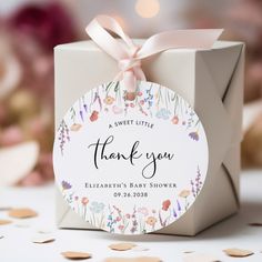 a white box with a pink ribbon on it and a thank you tag in the center