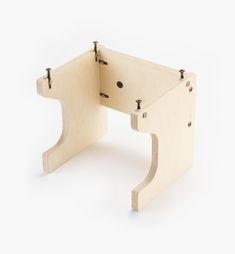 a small wooden table with two holes in it