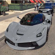 a silver sports car parked on the side of the road