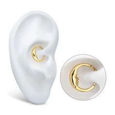 a pair of gold - plated ear piercings on top of a white background