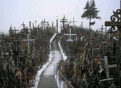 a hill covered in lots of crosses with snow on the ground