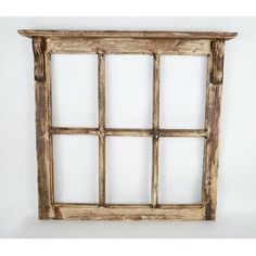 an old wooden window frame with four panes on the top and bottom, against a white background