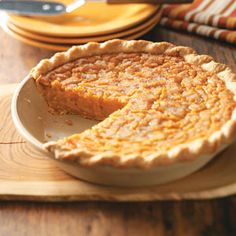 a pie sitting on top of a wooden cutting board