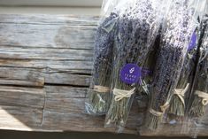 lavender flowers wrapped in cellophane and tied with twine on an old wooden bench